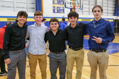 Award recipients posed together on the gym floor