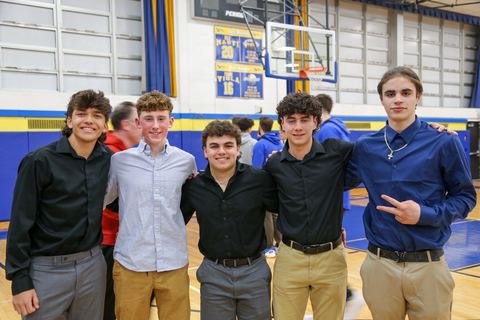 The group of award recipients posed in front of the basketball hoop