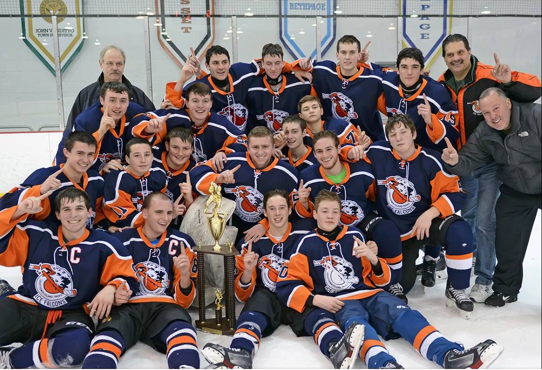 Ice Falcons players and coaches gathered around a championship trophy on the ice